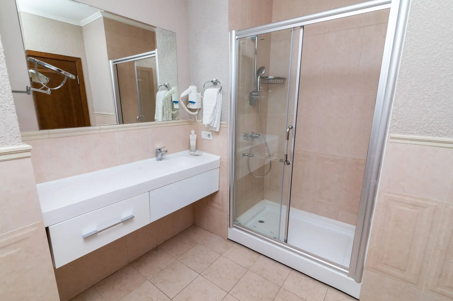 Contemporary bathroom showcasing a sleek shower cabin and minimalist interior design.